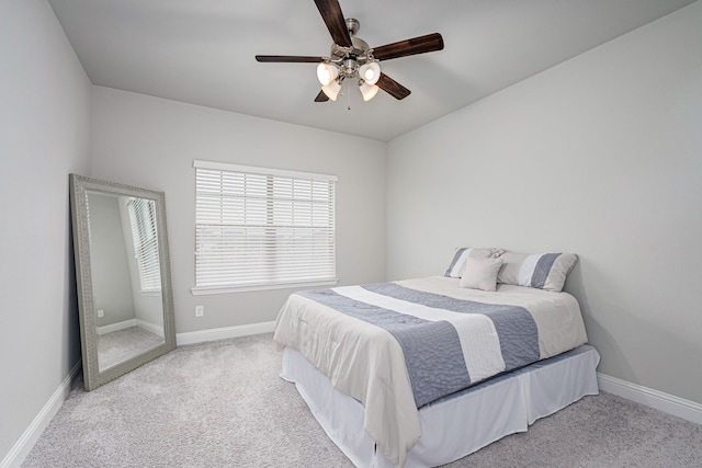 bedroom with light carpet and ceiling fan