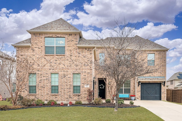 view of front of home with a garage and a front lawn