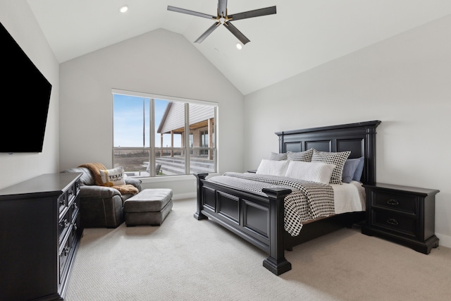 bedroom featuring lofted ceiling, a ceiling fan, and light colored carpet