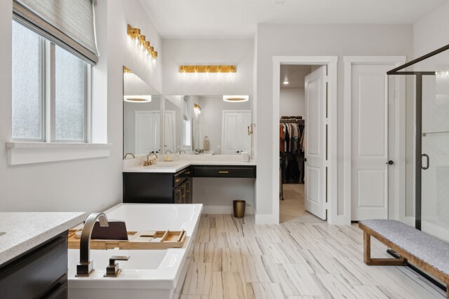 bathroom featuring vanity, a bathing tub, and vaulted ceiling