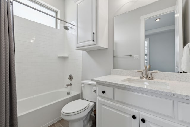 bathroom featuring toilet, shower / bath combination, wood finished floors, and vanity