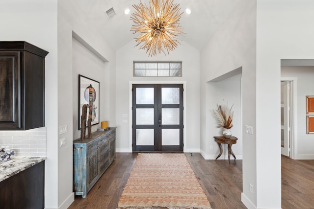 entryway featuring baseboards, visible vents, dark wood finished floors, french doors, and a chandelier