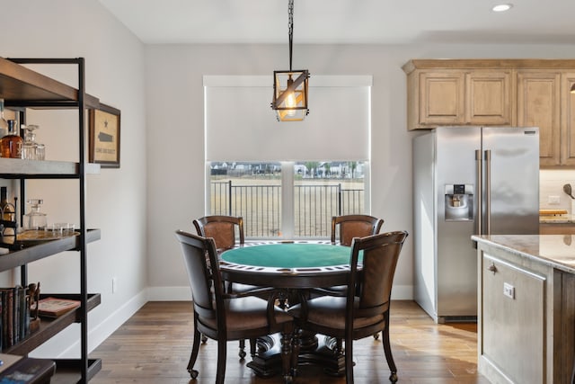 dining room featuring light wood-style flooring, baseboards, and recessed lighting