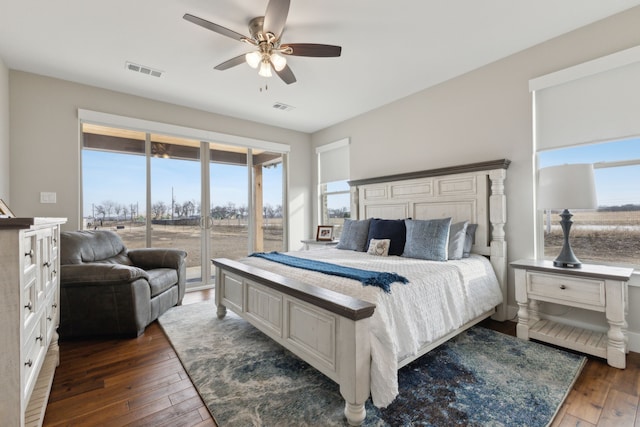 bedroom featuring access to outside, multiple windows, visible vents, and wood-type flooring