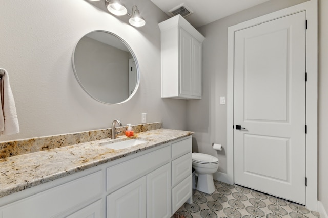 bathroom featuring toilet, tile patterned floors, visible vents, and vanity