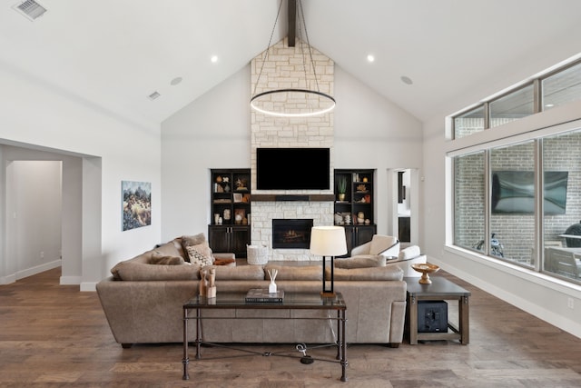 living room with wood-type flooring, a fireplace, high vaulted ceiling, and beam ceiling