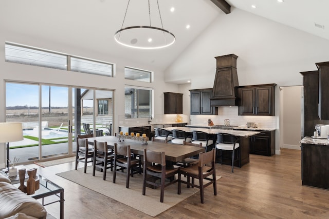 dining area with visible vents, light wood-type flooring, high vaulted ceiling, beam ceiling, and recessed lighting