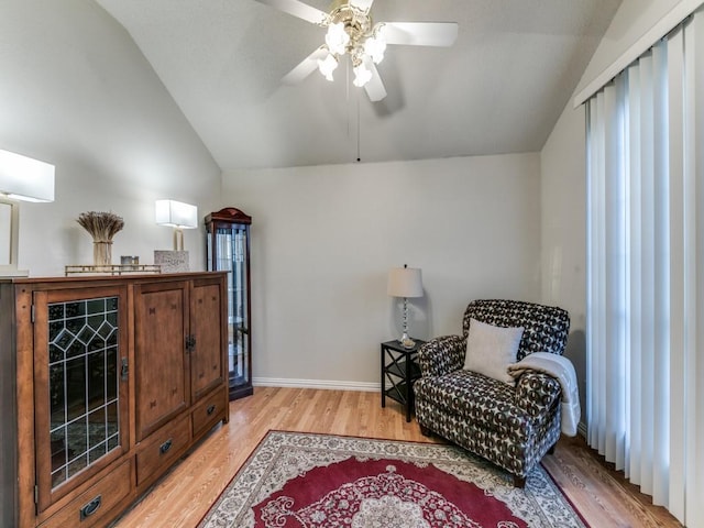 sitting room featuring ceiling fan, lofted ceiling, and light hardwood / wood-style floors