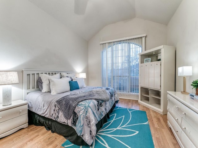 bedroom featuring vaulted ceiling, ceiling fan, and light wood-type flooring