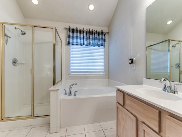 bathroom with tile patterned flooring, shower with separate bathtub, lofted ceiling, and vanity