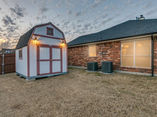 exterior space featuring a shed, central AC, and a lawn