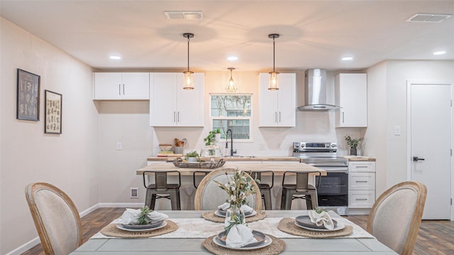 dining space with sink and dark wood-type flooring