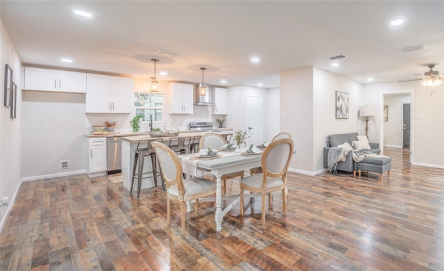 dining area featuring dark hardwood / wood-style floors, sink, and ceiling fan