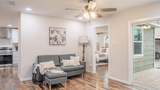 living room featuring dark hardwood / wood-style floors and ceiling fan