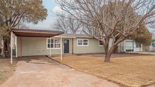 ranch-style house with a carport and central air condition unit