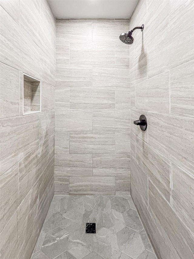 bathroom with tiled shower