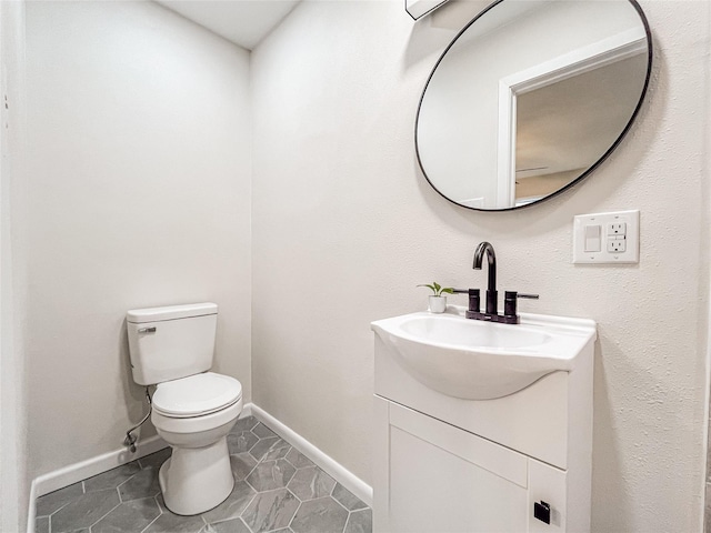 bathroom with vanity, toilet, and tile patterned flooring