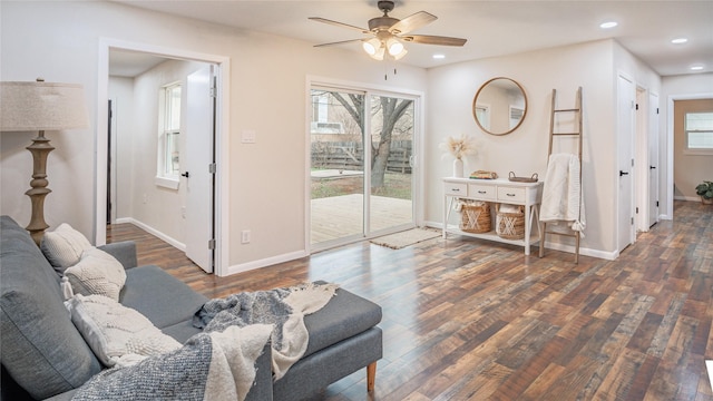 living room featuring dark hardwood / wood-style floors and ceiling fan