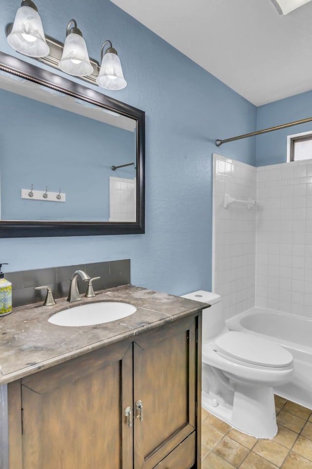 full bathroom with tiled shower / bath, vanity, toilet, and tile patterned flooring