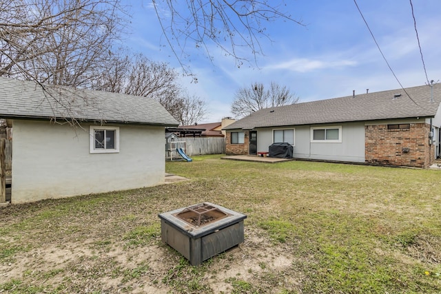 view of yard featuring a fire pit, a patio, and a playground