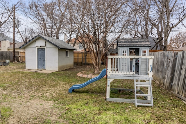 view of jungle gym with an outbuilding and a yard