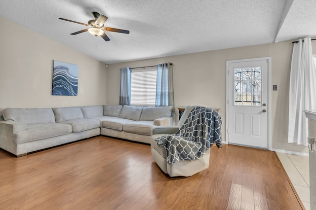 living room with hardwood / wood-style floors, plenty of natural light, a textured ceiling, and ceiling fan