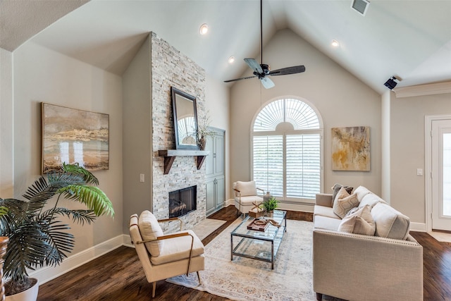 living room with dark wood-type flooring, ceiling fan, a fireplace, and high vaulted ceiling