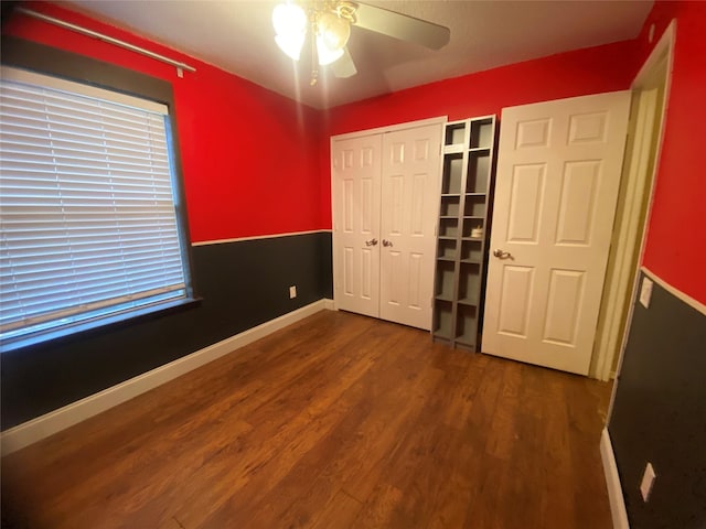 unfurnished bedroom featuring hardwood / wood-style flooring, a closet, and ceiling fan