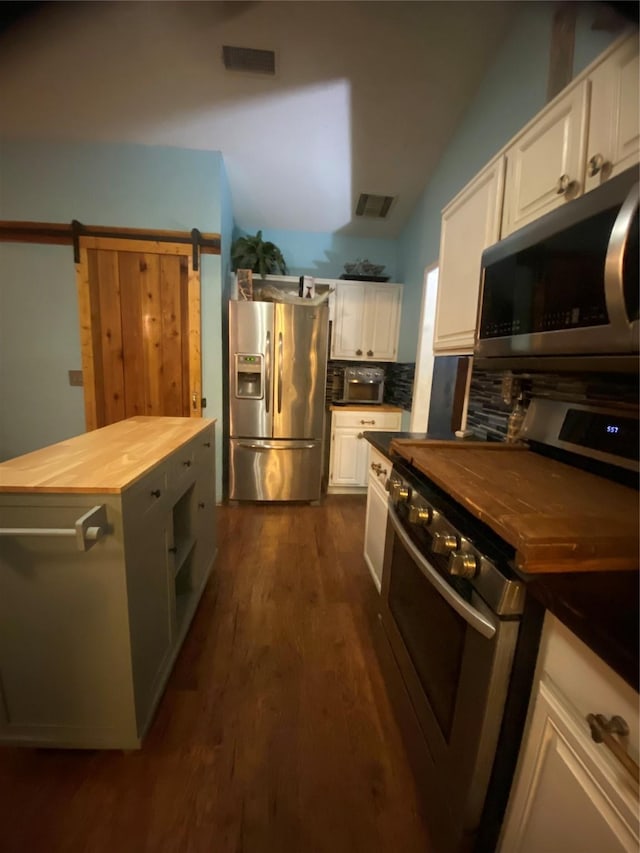 kitchen featuring butcher block counters, tasteful backsplash, dark hardwood / wood-style floors, stainless steel appliances, and white cabinets