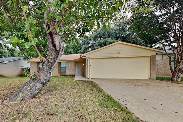 ranch-style house featuring a garage and a front yard