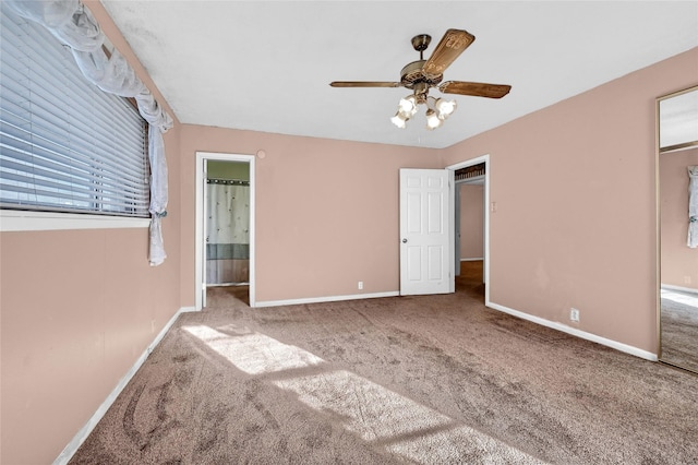 unfurnished bedroom featuring ensuite bathroom, carpet flooring, and ceiling fan