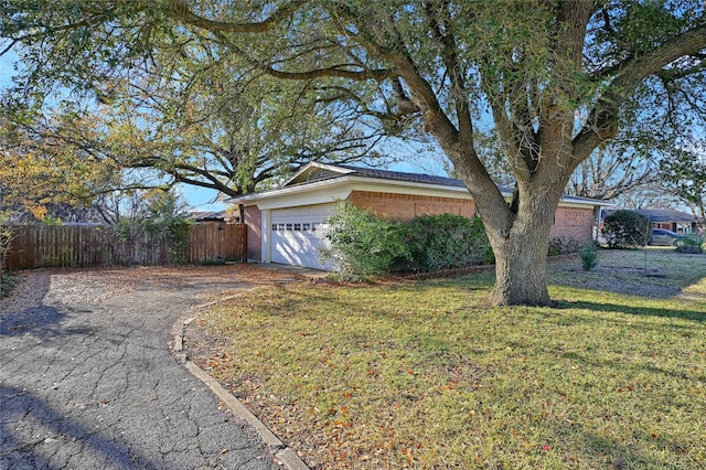 view of front of property with a garage and a front lawn