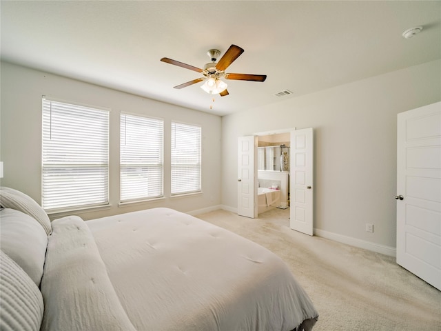 carpeted bedroom with connected bathroom and ceiling fan