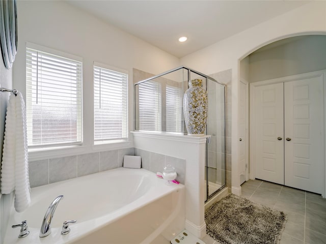 bathroom with tile patterned floors and plus walk in shower