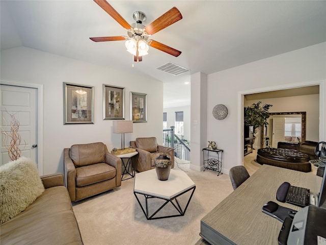 living room featuring vaulted ceiling, light carpet, and ceiling fan