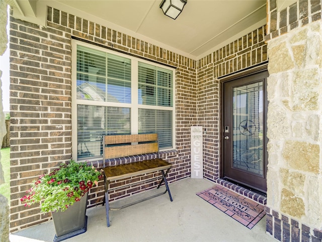 view of exterior entry featuring covered porch