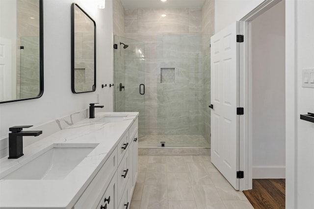 bathroom featuring vanity and a shower with shower door