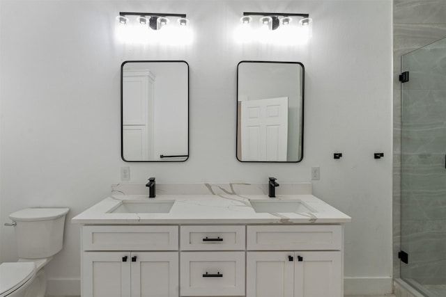 bathroom featuring vanity, an enclosed shower, and toilet