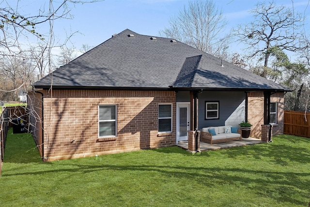 back of house featuring a patio area and a lawn