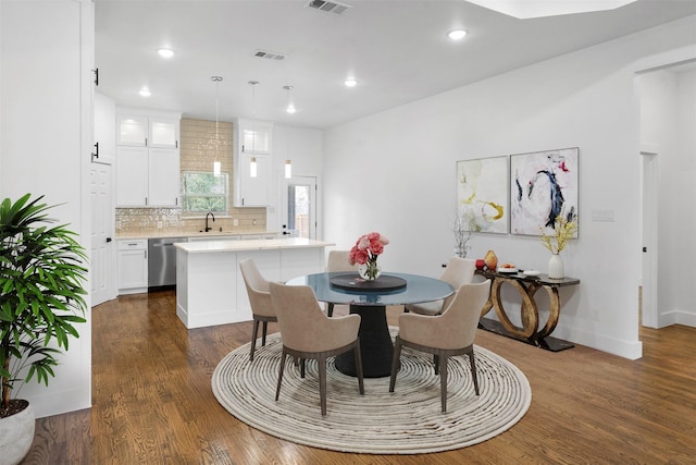 dining room with dark hardwood / wood-style floors and sink