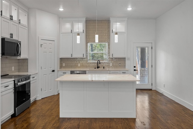 kitchen with stainless steel appliances, a center island, and white cabinets