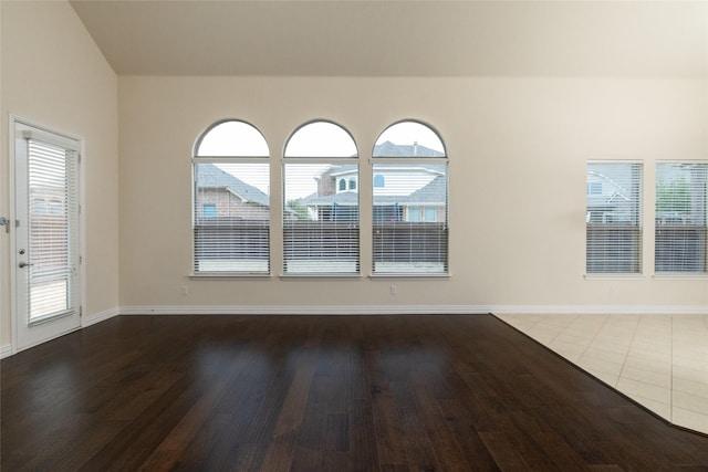 empty room featuring baseboards and wood finished floors