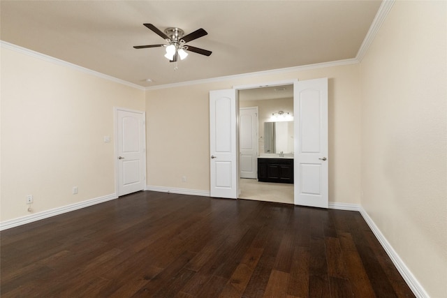 interior space with baseboards, ceiling fan, wood finished floors, crown molding, and a sink