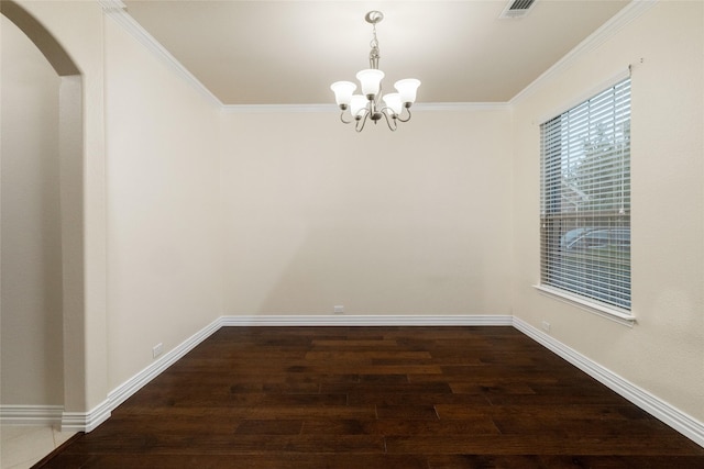 unfurnished dining area featuring arched walkways, wood finished floors, ornamental molding, baseboards, and a notable chandelier