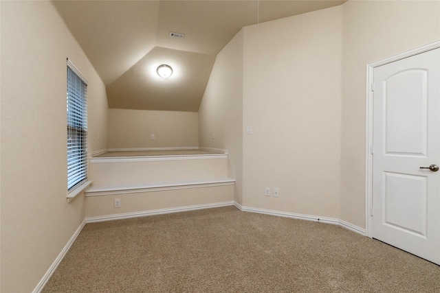 additional living space featuring lofted ceiling, carpet floors, visible vents, and baseboards