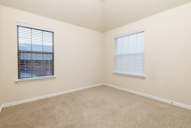 carpeted empty room with baseboards