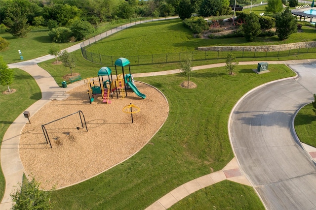 community playground with fence and a lawn