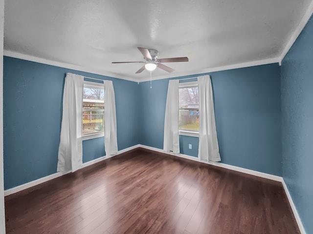 empty room featuring crown molding, wood-type flooring, and ceiling fan