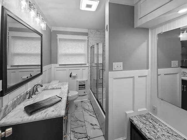 bathroom with a shower with door, vanity, heating unit, and toilet