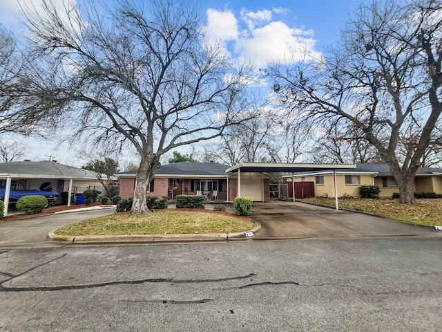 view of front of home with a carport and a garage